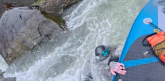 Standup paddleboarder saves kayaker with bold rescue.